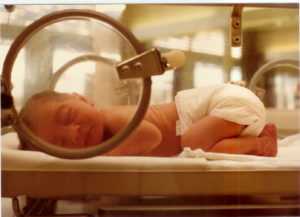 new born baby sleeping in incubator