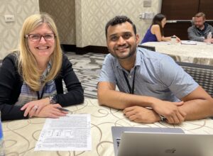 two members posing while working on a grant writing project