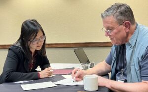 During the PRS YIGWW, Mancy Tong, PhD meets with workshop faculty member, Robert Lane, MD.