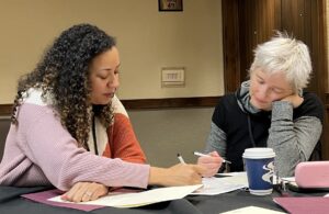 Drs Mariana Brewer (left) and Sonnet Jonker (Workshop Faculty) review Brewer's grant application at PRS Young Investigator Grant Writing Workshop