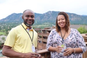 Two scientists attend opening reception at annual scientific meeting in Colorado Springs, CO.