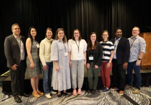 Associate members of national perinatal research society gather after speaking at national meeting.