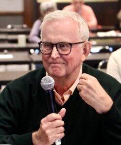 Distinguished society member questions a speaker.