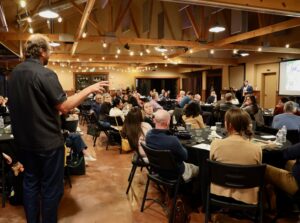 Leader provides instruction at evening session at annual meeting.