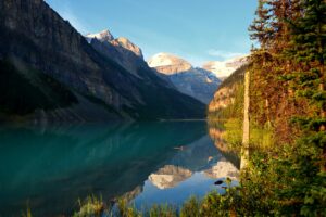 waterfront view with mountains and trees in the background Banff, Alberta, Canada