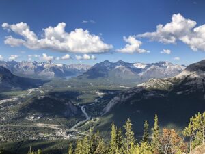 clouds mountains and scenic view of the city and landscape