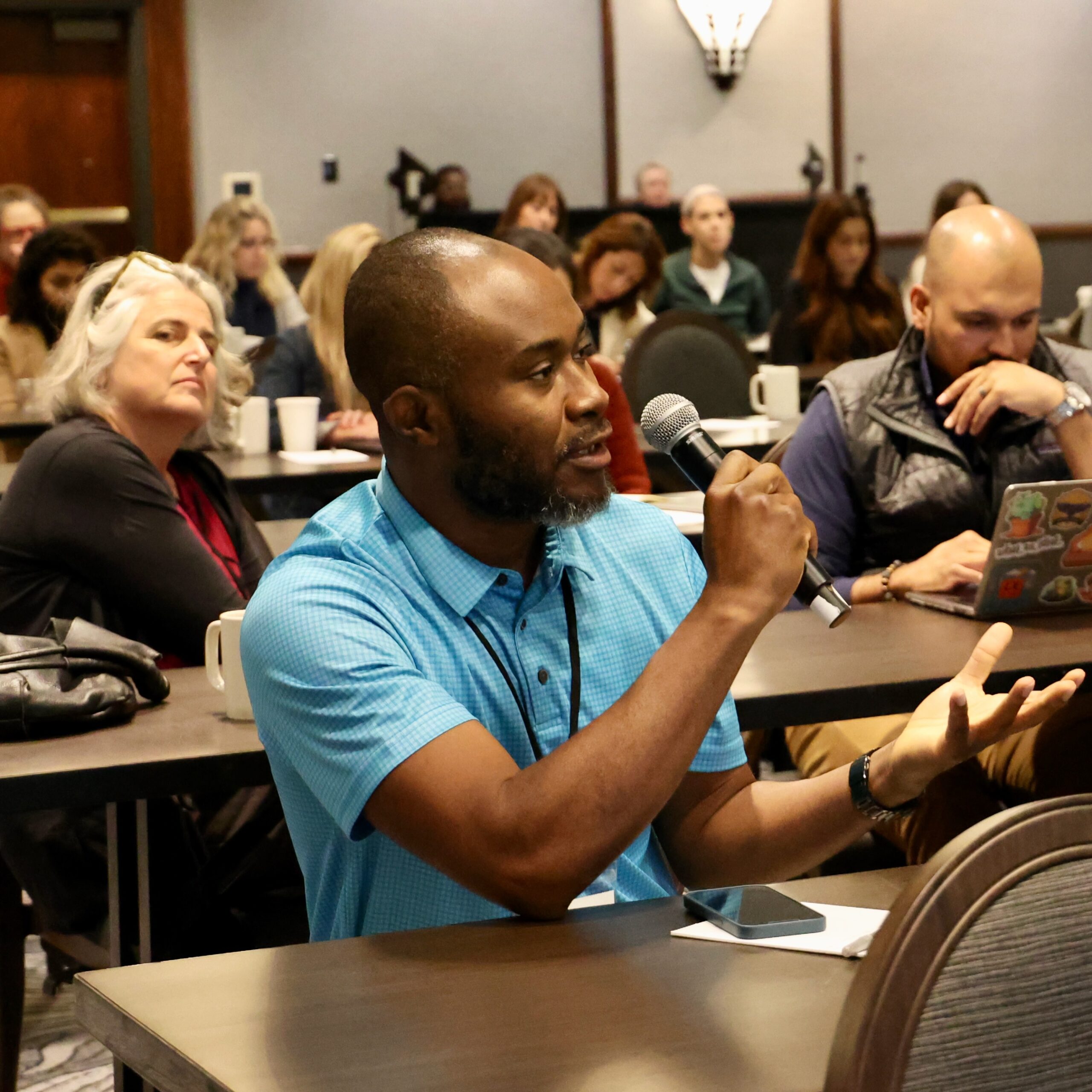 PRS Member member speaking with a microphone during meeting discussion