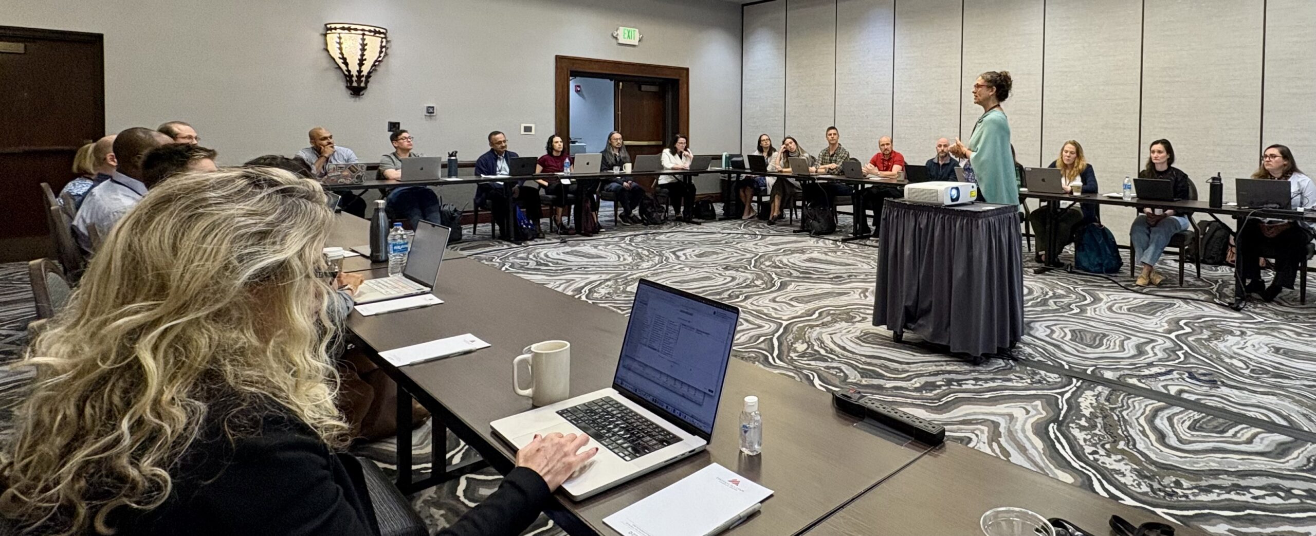 PRS leadership lecturing the workshop while participants take notes